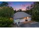 Aerial view of a detached garage featuring three bays and a landscaped yard at dusk at 10914 Remmick Ridge Rd, Parker, CO 80134
