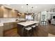 Spacious kitchen with a large island, seating, stainless steel appliances, custom cabinetry, and wood flooring at 10914 Remmick Ridge Rd, Parker, CO 80134