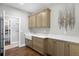 Well-organized laundry room with ample cabinet space, countertop, a large sink, and modern decor at 10914 Remmick Ridge Rd, Parker, CO 80134