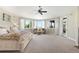 Spacious main bedroom offering an abundance of natural light, comfortable seating area, and exterior access to a deck at 10914 Remmick Ridge Rd, Parker, CO 80134