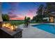 Relaxing backyard pool with a modern fire pit, garden, and incredible sunset view at 10914 Remmick Ridge Rd, Parker, CO 80134