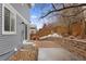 Cozy backyard features a retaining wall, tiered landscaping, and a small patio, perfect for relaxation at 1963 Hogan Ct, Castle Rock, CO 80109