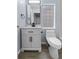 Cozy bathroom featuring a modern vanity, fixtures, and a unique glass block window at 1963 Hogan Ct, Castle Rock, CO 80109