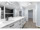 Modern bathroom features double sinks, sleek white cabinets, and a large mirror with modern light fixture at 1963 Hogan Ct, Castle Rock, CO 80109