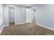 Neutral-toned bedroom with a large walk-in closet and multiple entrances, complemented by soft carpeting at 1963 Hogan Ct, Castle Rock, CO 80109