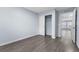 Bedroom with hardwood floors, closet, and light-filled open doorway at 1963 Hogan Ct, Castle Rock, CO 80109