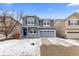 Charming two-story home with a covered front porch, shutters, and a two-car garage at 1963 Hogan Ct, Castle Rock, CO 80109