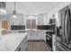 Modern kitchen with new white cabinets, stainless steel appliances, a black subway tile backsplash, and an island at 1963 Hogan Ct, Castle Rock, CO 80109