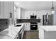 Modern kitchen with new white cabinets, stainless steel appliances, a black subway tile backsplash, and an island at 1963 Hogan Ct, Castle Rock, CO 80109