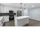 Modern kitchen with new white cabinets, stainless steel appliances, a black subway tile backsplash, and an island at 1963 Hogan Ct, Castle Rock, CO 80109