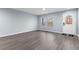 Bright living room featuring stylish gray floors, fresh paint, a front door and two windows at 1963 Hogan Ct, Castle Rock, CO 80109