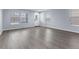 Bright living room with hardwood floors and natural light from the large windows and a front door at 1963 Hogan Ct, Castle Rock, CO 80109