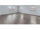 Bright living room with hardwood floors and plenty of natural light from the large windows at 1963 Hogan Ct, Castle Rock, CO 80109