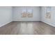 Bright living room with hardwood floors and plenty of natural light from the large windows at 1963 Hogan Ct, Castle Rock, CO 80109