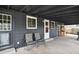 Covered back porch with seating, perfect for outdoor relaxation and entertainment at 3975 S Jason St, Englewood, CO 80110