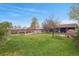 Spacious backyard featuring garden beds, a lush lawn, and a pizza oven at 3975 S Jason St, Englewood, CO 80110