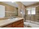 Bathroom featuring a shower and tub combo with beautiful tile and modern fixtures at 3975 S Jason St, Englewood, CO 80110