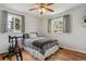 Inviting bedroom featuring hardwood floors, a ceiling fan, and natural light at 3975 S Jason St, Englewood, CO 80110