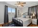 Cozy bedroom featuring hardwood floors, neutral bedding, and stylish window curtains at 3975 S Jason St, Englewood, CO 80110