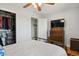 Bright bedroom featuring a ceiling fan, closet, and antique dresser with a TV at 3975 S Jason St, Englewood, CO 80110