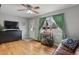 Well-lit living room with hardwood floors, bar cart, and decorative curtains at 3975 S Jason St, Englewood, CO 80110