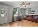 Bright living room showcasing hardwood floors, a leather sofa, and a bar cart at 3975 S Jason St, Englewood, CO 80110