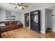 Cozy living room featuring hardwood floors, leather sofa, and ceiling fan at 3975 S Jason St, Englewood, CO 80110