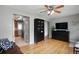 Comfortable living room featuring hardwood floors, tv, and black cabinet at 3975 S Jason St, Englewood, CO 80110