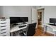 Office space featuring hardwood floors and a glimpse into the adjacent bathroom at 3975 S Jason St, Englewood, CO 80110