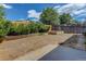 Fenced backyard with lawn, raised garden beds, and room for outdoor activities at 3854 S Olathe Cir, Aurora, CO 80013