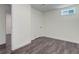 Finished basement with neutral walls, wood floors, and a white door frame at 3854 S Olathe Cir, Aurora, CO 80013