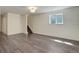 Finished basement with new hardwood floors, neutral walls, and staircase access at 3854 S Olathe Cir, Aurora, CO 80013