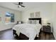 Cozy bedroom with a comfortable bed, ceiling fan, and a window allowing natural light at 3854 S Olathe Cir, Aurora, CO 80013