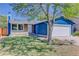 Charming blue home with stone accents, solar panels, well-kept lawn, and attached two-car garage at 3854 S Olathe Cir, Aurora, CO 80013