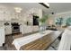 Open kitchen with stainless steel appliances, white cabinets, and a dining area at 3854 S Olathe Cir, Aurora, CO 80013