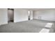 Spacious basement with neutral carpet and view to utility room at 12164 E Amherst Cir, Aurora, CO 80014