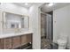 Well-lit bathroom featuring a new vanity, shower, and modern fixtures at 12164 E Amherst Cir, Aurora, CO 80014