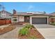 Charming single-Gathering home with a well-manicured front yard, solar panels, and an attached garage at 12164 E Amherst Cir, Aurora, CO 80014