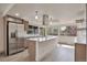 Well-lit kitchen with a large island, stainless steel appliances, and modern fixtures at 12164 E Amherst Cir, Aurora, CO 80014