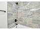 Modern shower stall featuring upscale black fixtures and light gray tile at 12164 E Amherst Cir, Aurora, CO 80014