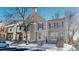 Attractive townhome exterior with snow-covered landscaping at 1811 S Quebec Way # 194, Denver, CO 80231
