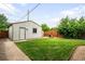 This backyard features a detached garage, a well-manicured lawn, and a privacy fence at 2255 Perry St, Denver, CO 80212