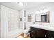 A bright bathroom features white tiles in the shower, contrasting the dark vanity cabinet at 2255 Perry St, Denver, CO 80212