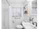 A bathroom features white wainscoting, a white vanity, and a shower with a white shower curtain at 2255 Perry St, Denver, CO 80212