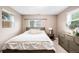 A primary bedroom is decorated with neutral tones and two windows that offer natural light at 2255 Perry St, Denver, CO 80212