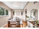 Elegant dining room featuring hardwood floors, a long wooden table and a classic light fixture at 2255 Perry St, Denver, CO 80212