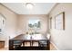 Dining room features a wooden dining table, wood floors, overhead lighting, and natural light from a window at 2255 Perry St, Denver, CO 80212