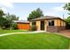 Charming single-story home with a lush green lawn, brick accents, and a welcoming front entrance at 2255 Perry St, Denver, CO 80212