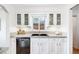 Charming kitchen featuring sleek black appliances, white cabinets and countertops with granite accents at 2255 Perry St, Denver, CO 80212