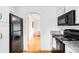 Efficient kitchen layout features a refrigerator, an oven, and a view into another room at 2255 Perry St, Denver, CO 80212